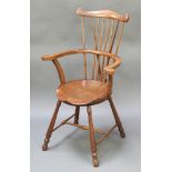 An Arts & Crafts beech framed stick and wheel back Windsor chair with H framed stretcher There is an