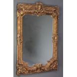 A rectangular plate wall mirror contained in a decorative ornate frame 49"h x 30"w