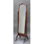 A 1920's cheval mirror contained in an oak frame 60"h x 15 1/2"w x 19 1/2"d The silvering to the