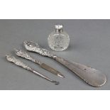 A silver mounted cut glass scent bottle and 3 silver handled implements