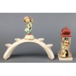 A Hummel 4 light candle holder surmounted by an angel 10 1/2", a ditto group of figures on a bell