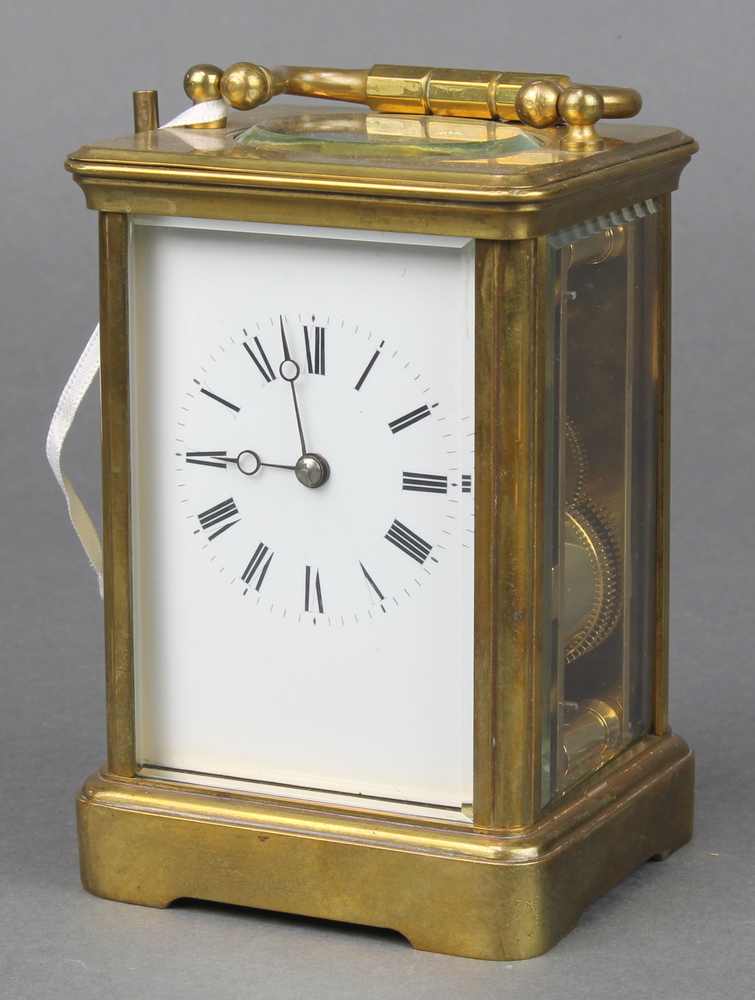 A French 19th Century 8 day striking carriage clock with enamelled dial and Roman numerals contained