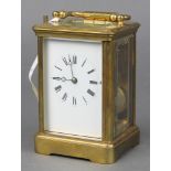 A French 19th Century 8 day striking carriage clock with enamelled dial and Roman numerals contained
