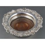 A 19th Century silver plated champagne coaster with floral and scroll rim