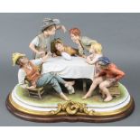 A large Capodimonte group of 6 children sitting around a table watching a magic trick, 20"