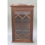 An Edwardian Chippendale style mahogany corner cabinet with moulded cornice and blind fret work