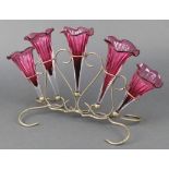 An Edwardian silver plated 5 section epergne with cranberry glass flutes on a wire work base
