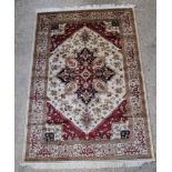 A Belgian cotton white and red ground Heriz style rug with central medallion 92" x 63"