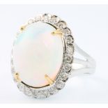 An 18ct white gold oval opal and diamond cluster ring the centre stone approx. 6.28ct surrounded