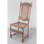 A Victorian carved walnut Carolean style high back chair with carved cresting rail decorated cherubs