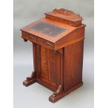 An Edwardian carved walnut Davenport the back fitted a stationery box with cupboard 34"h x 21"w x