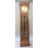 A 1930's chiming longcase clock with 10" silvered dial and Arabic numerals contained in an oak and