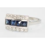 An 18ct white gold sapphire and diamond ring with 4 princess cut sapphires flanked by brilliant