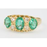 An 18ct yellow gold emerald and diamond Victorian style ring size N 1/2