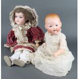 Armand Marseille a porcelain headed doll with open and shutting eyes, open mouth with 2 teeth the