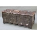 An 18th/19th Century carved oak coffer of panelled construction with hinged lid 24"h x 57 1/2"w x