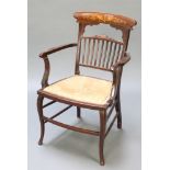 An Edwardian inlaid mahogany open arm carver chair with stick and bar back and upholstered seat,