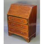 An Edwardian inlaid mahogany bureau, the fall front revealing a fitted interior above 3 long