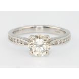 An 18ct white gold single stone brilliant cut diamond ring, approx. 1.2ct , the shoulders with 7