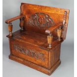 A carved oak monks bench with hinged lid, heavily carved throughout 29 1/2"h x 36"w x 19"d There are
