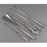 A silver handled shoe horn and 4 ditto button hooks with rubbed marks