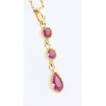 A 9ct yellow gold 3 stone ruby drop pendant and chain