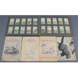 An album of cigarette cards including Players motor cars, aeroplanes (civil), album of Wills railway