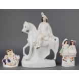 A Victorian Staffordshire figure of a Scotsman on horseback 14 1/2", a ditto of a Scottish couple
