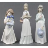 3 Nao figures - a girl with doll 8", a girl holding a hat 9" and a girl with a puppy 9"