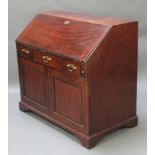 A Georgian mahogany bureau, the fall front revealing a well fitted interior above 1 long and 2 short