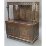 A 17th/18th Century oak court cupboard with raised carved and pierced back, panel decoration, the