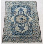 A blue and white ground Tabriz rug with central medallion, 65 1/2" x 45 1/2" There is a small hole