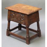 A rectangular carved oak joined stool/storage box with hinged lid, the top of plank construction,