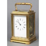 A 19th Century French 8 day striking carriage clock with enamelled dial and Roman numerals contained