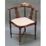 An Edwardian inlaid mahogany corner chair with pierced vase slat back and upholstered back raised on