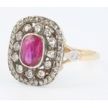 A yellow gold ruby and diamond Edwardian style ring, the centre stone approx 0.8ct surrounded by