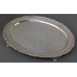 A Victorian silver oval tray with floral rim, the centre engraved with scrolls and flowers,