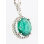 An 18ct white gold emerald and diamond oval pendant, the centre stone approx 2.56ct surrounded by