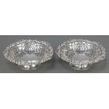 A pair of George III Irish pierced silver bowls with shell and floral borders and pierced decoration