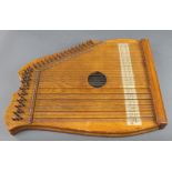 A wooden harp zither 21" x 16"