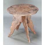 A Kashmir circular carved table, raised on folding stand 17"h x 18" diam.