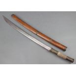 A 'Burmese' tribal sword with a 24" curved blade and metal shagreen mounted grip, contained in a wo