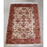 A gold and copper ground Ziegler rug with floral ground 76" x 52"