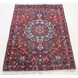 A red and blue ground Bakhtiari rug with central medallion 79" x 55" There are signs of wear, damage