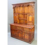 A 17th/18th Century oak style oak dresser, the raised back with moulded and pierced cornice above