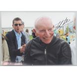 John Surtees, a signed colour photograph of John Surtees wearing a black leather motorcycle jacket