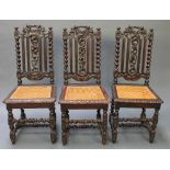 A set of 3 Victorian Carolean style high back chairs with pierced backs, the seats with woven cane