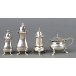 A silver mustard with S scroll handle and pad feet, London 1922 and 3 pepperettes 208 grams
