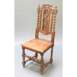 A Victorian light oak Carolean style high back hall chair with solid seat, carved cresting rail