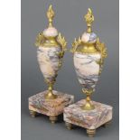 A pair of 19th Century Continental pink veined marble urns with gilt metal mounts 11"